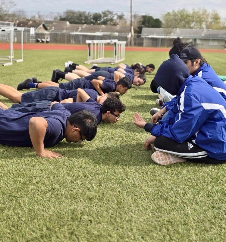 CHS NJROTC cadets performing PT and standing in formation during the Coastal Bend Classic Drill Meet.