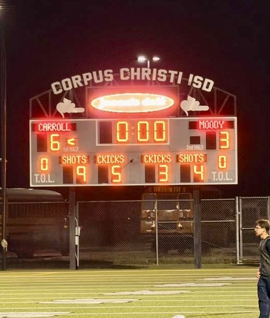 Carroll Tigers soccer team posing together on the field after a win. • Scoreboard shows Carroll defeating Moody, 6–3.