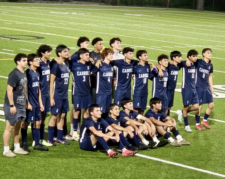 Carroll Tigers soccer team posing together on the field after a win. • Scoreboard shows Carroll defeating Moody, 6–3.