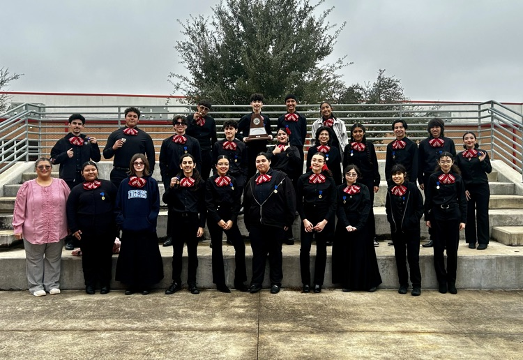 Mariachi Los Tigres celebrating with Sweepstakes trophy after qualifying for state.