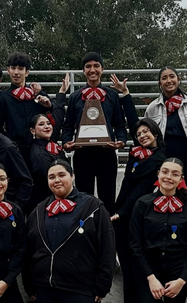 Mariachi Los Tigres celebrating with Sweepstakes trophy after qualifying for state.