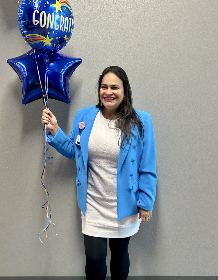 Staff celebrating Señora Rodriguez with balloons and a cookie cake in her classroom. 🎉🍪💙