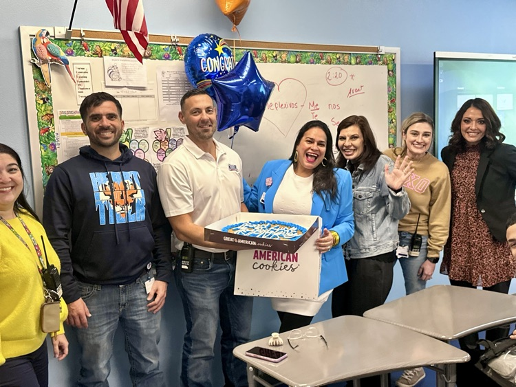 Staff celebrating Señora Rodriguez with balloons and a cookie cake in her classroom. 🎉🍪💙