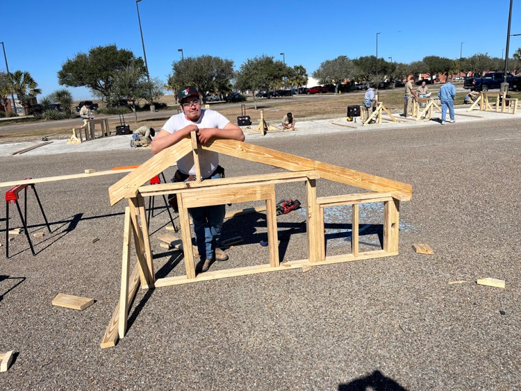 Alt text: Carroll students building wood framing projects outdoors at the District SkillsUSA competition while competing for a spot at state.