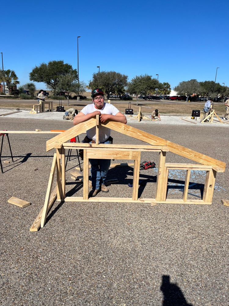 Alt text: Carroll students building wood framing projects outdoors at the District SkillsUSA competition while competing for a spot at state.