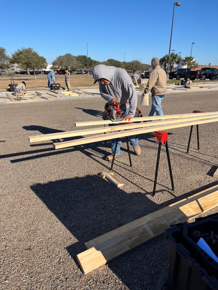 Alt text: Carroll students building wood framing projects outdoors at the District SkillsUSA competition while competing for a spot at state.