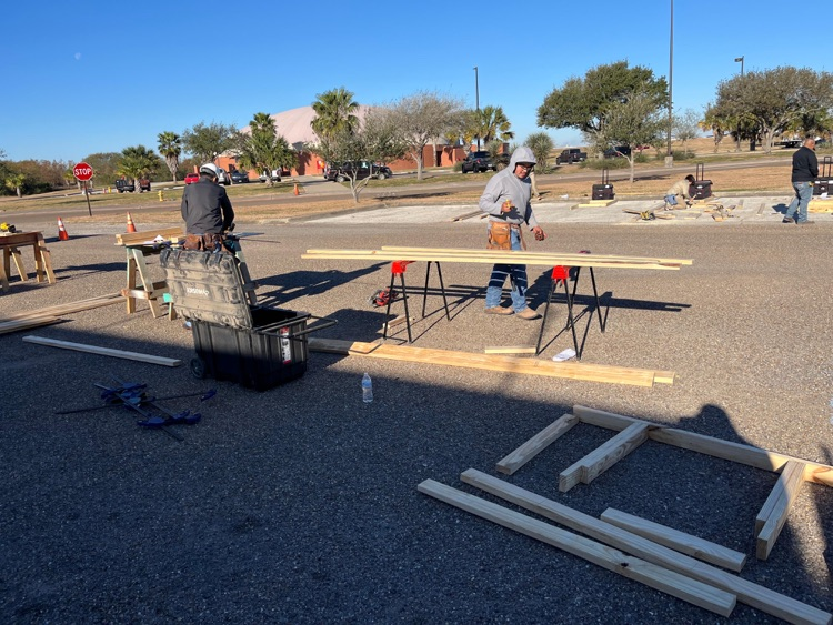 Alt text: Carroll students building wood framing projects outdoors at the District SkillsUSA competition while competing for a spot at state.