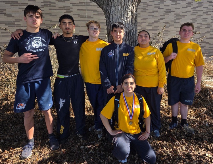 Alt text: Carroll NJROTC cadets posing together outdoors after earning medals at a Lone Star Orienteering event.