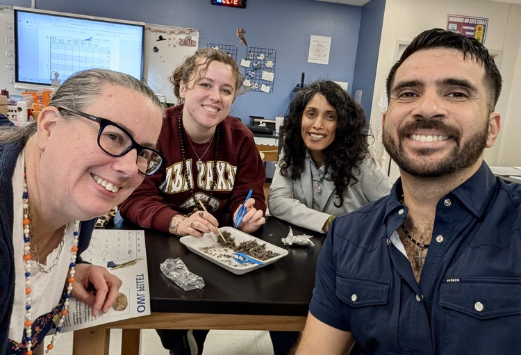 Alt Text: Carroll High School science teachers working together in a lab classroom dissecting owl pellets and identifying bones during Professional Development Day.