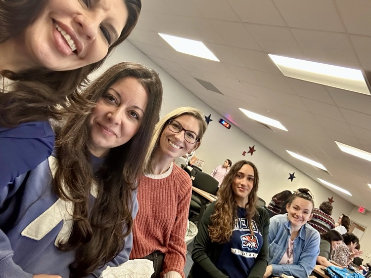 Alt Text: English 2 teachers smiling together during Professional Development Day in a classroom setting at Carroll High School.