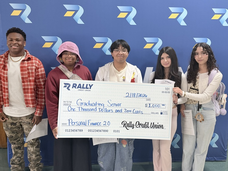 ⸻ Short alt text: Five Carroll students pose with a $1,000 scholarship check from Rally Credit Union.