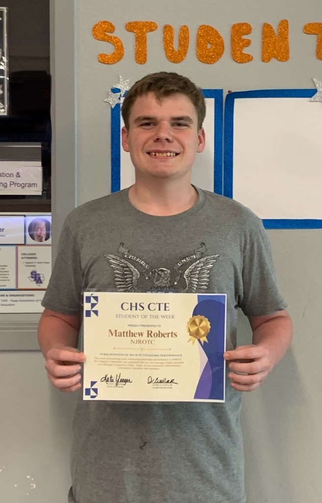 Student holding a CHS CTE Student of the Week certificate for NJROTC in front of a “Star Student” display.