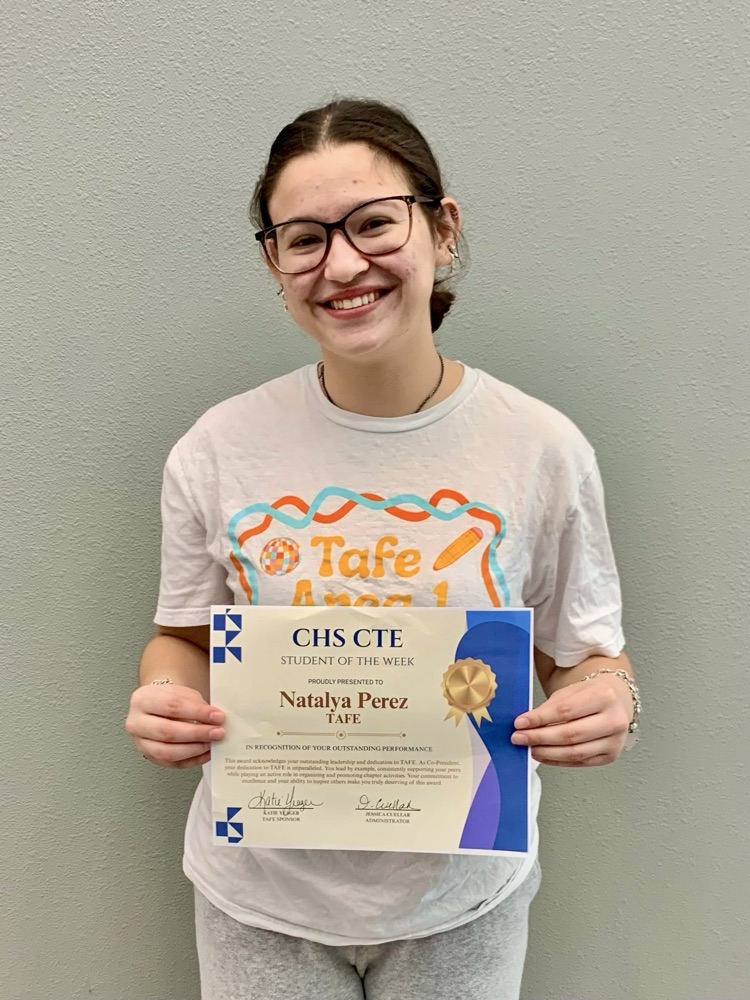 Alt text: Student smiling and holding her CTE Student of the Week certificate.