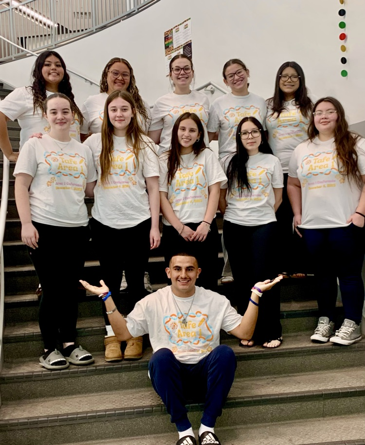 TAFE Students smiling at school event.