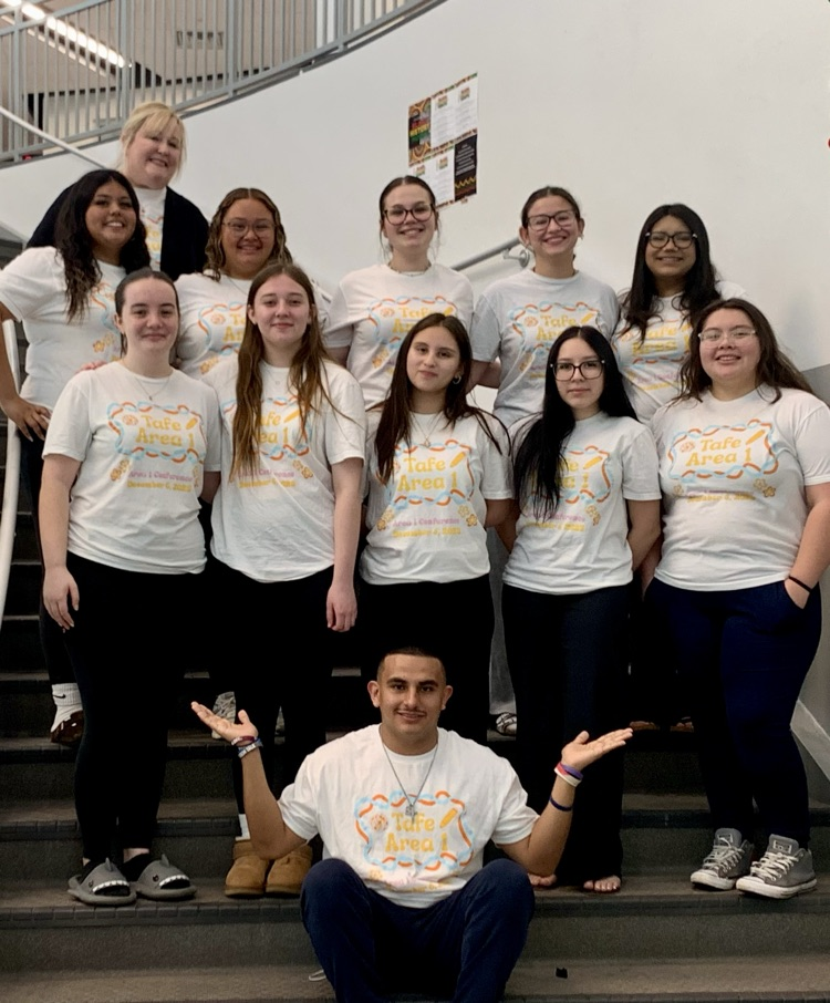 TAFE Students smiling at school event.