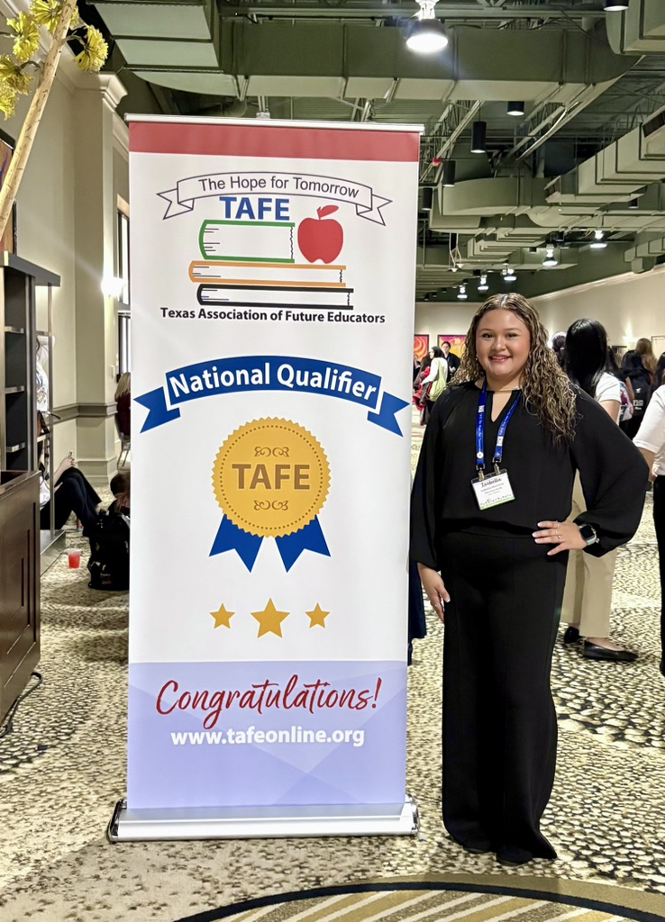 Two Carroll TAFE students stand beside a National Qualifier banner after advancing to Nationals in Children’s Literature and Interactive Bulletin Board.