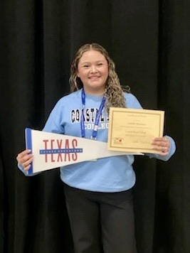 TAFE students sign college commitments as education majors at the state competition in Dallas, holding certificates and college pennants.