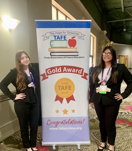 Carroll student displays medal, certificate, and project board as a TAFE Winner 