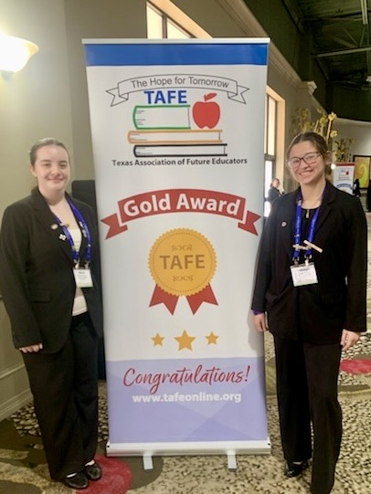 Carroll student displays medal, certificate, and project board as a TAFE Winner 