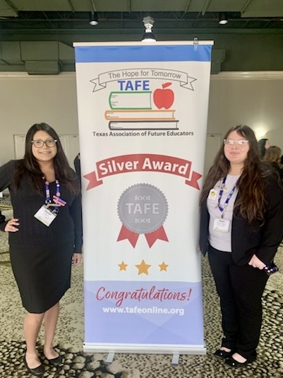 Carroll student displays medal, certificate, and project board as a TAFE Winner 