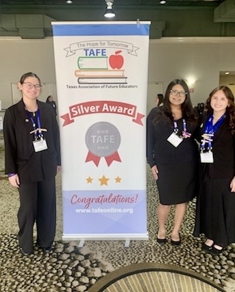 Carroll student displays medal, certificate, and project board as a TAFE Winner 