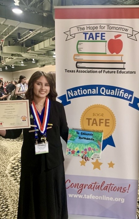 Carroll student displays medal, certificate, and project board as a TAFE Winner 