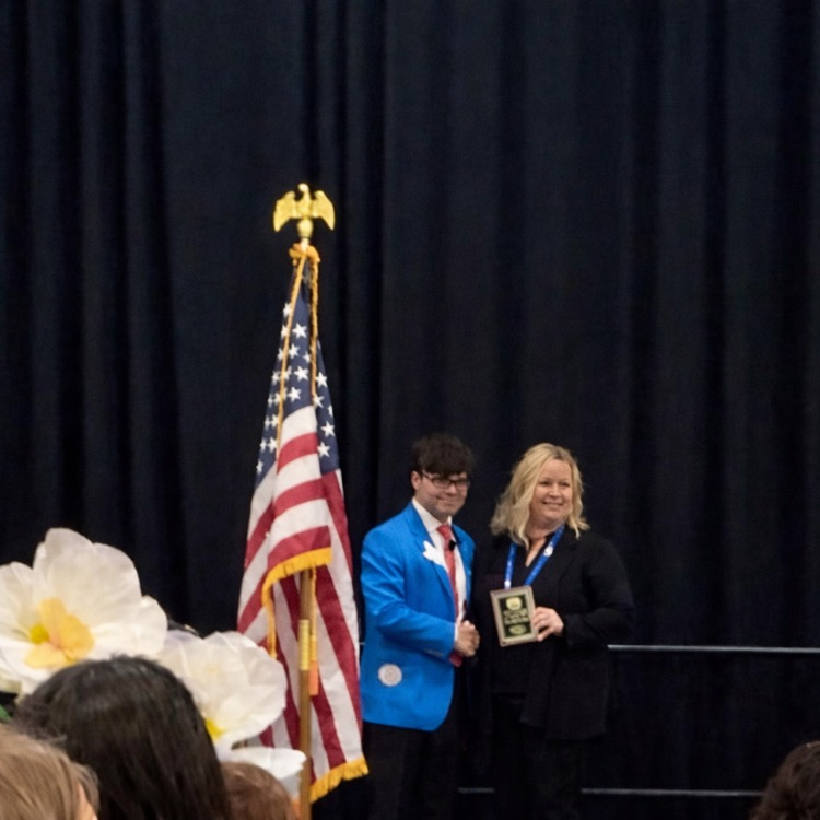 Carroll student displays medal, certificate, and project board as a TAFE Winner 