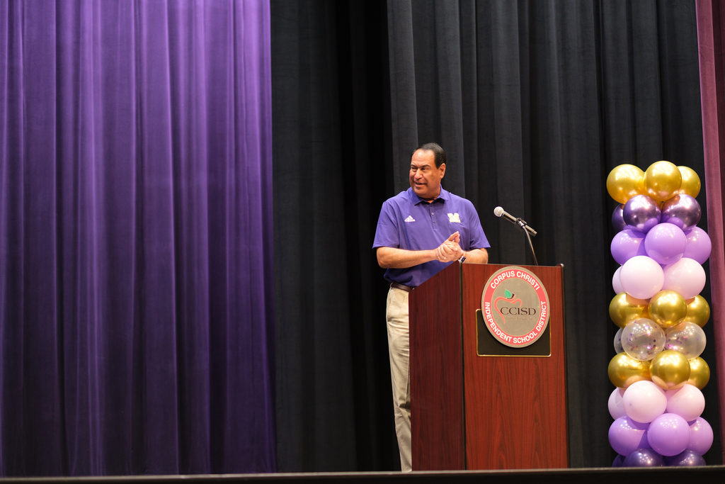 Superintendent Dr. Roland Hernandez speaking at a podium. 