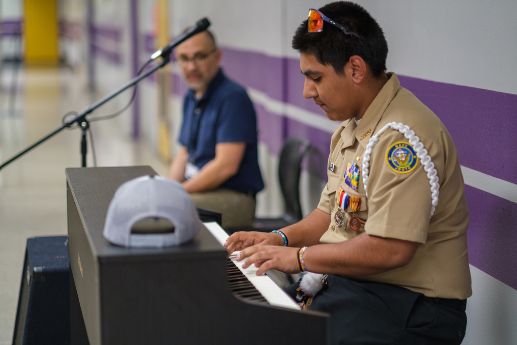 A Miller High School student playing the piano.
