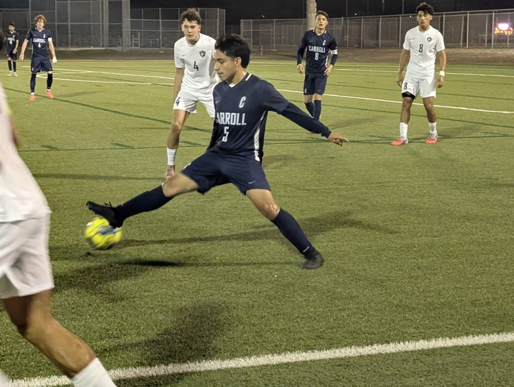 Alt Text: Carroll High School boys soccer players competing during a match, showing teamwork, intensity, and Tiger pride on the field.