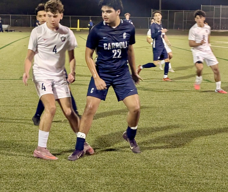 Alt Text: Carroll High School boys soccer players competing during a match, showing teamwork, intensity, and Tiger pride on the field.