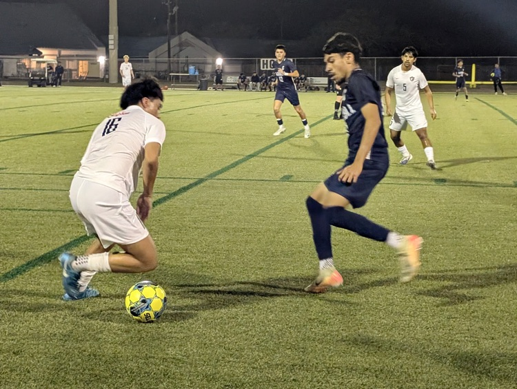 Alt Text: Carroll High School boys soccer players competing during a match, showing teamwork, intensity, and Tiger pride on the field.
