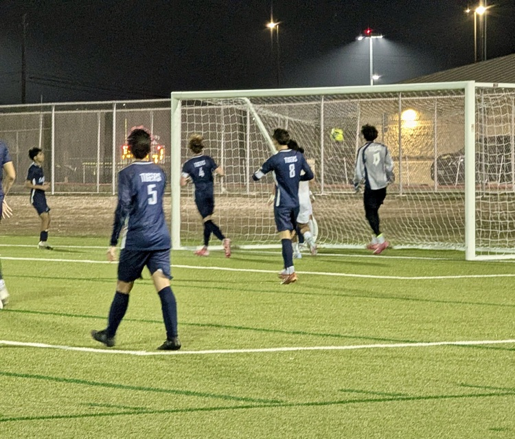 Alt Text: Carroll High School boys soccer players competing during a match, showing teamwork, intensity, and Tiger pride on the field.