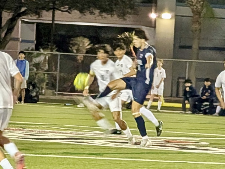 Alt Text: Carroll High School boys soccer players competing during a match, showing teamwork, intensity, and Tiger pride on the field.