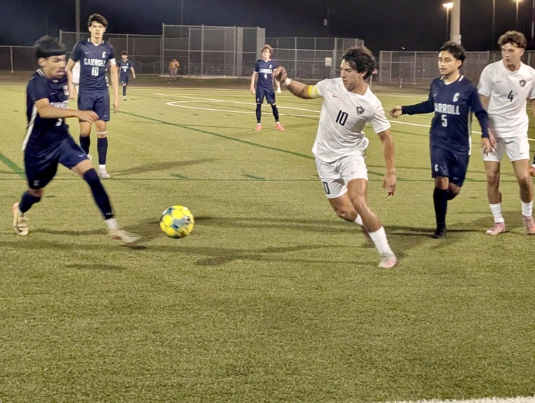 Alt Text: Carroll High School boys soccer players competing during a match, showing teamwork, intensity, and Tiger pride on the field.