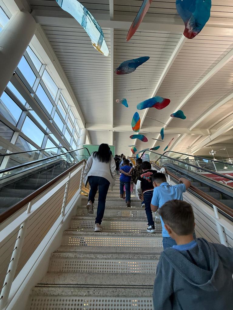 Mariners take the stairs as they walk towards the gates and the TSA checkpoint.