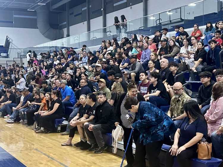 Students walk through a crowded high school hallway during Tiger Cub Camp, talking and smiling as they explore campus.