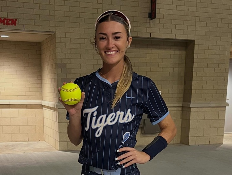 Alt Text: A high school softball player, Kaeleigh Mendez, is shown hitting or celebrating a powerful hit during a game, highlighted as a home run for the Lady Tigers.