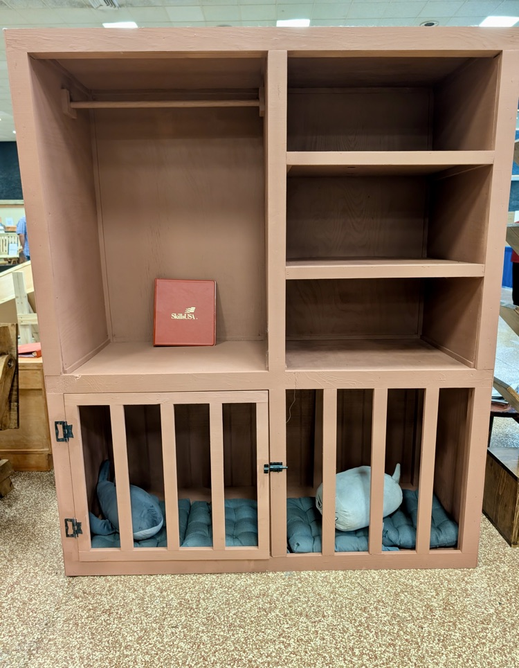 Alt text: Handcrafted wooden box with metal latch on display 