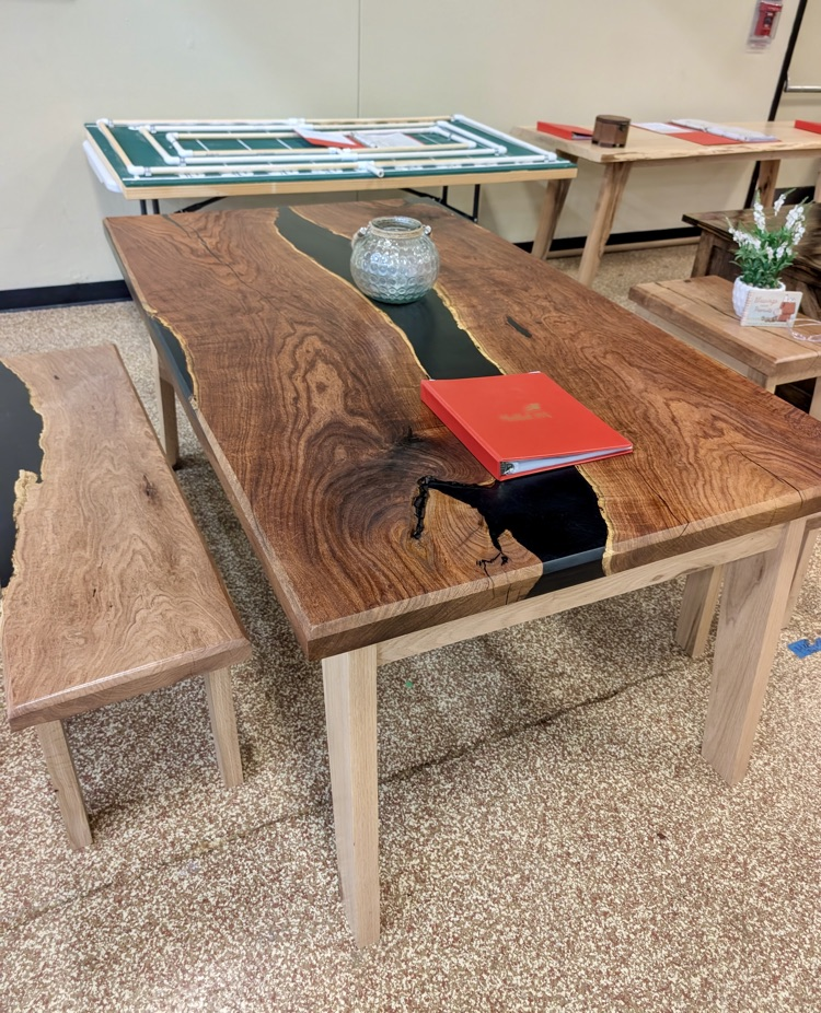 Alt text: Handcrafted wooden box with metal latch on display 