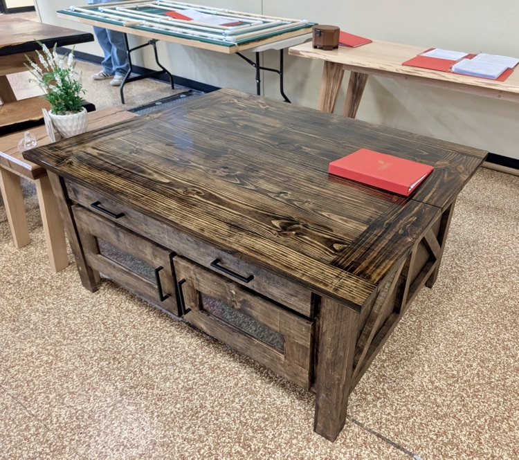 Alt text: Handcrafted wooden box with metal latch on display 