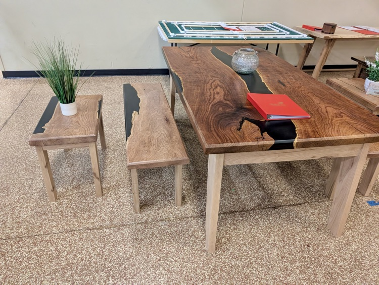Alt text: Handcrafted wooden box with metal latch on display 