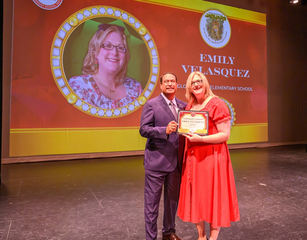 Dr. roland hernandez and emily velasquez pose for a photo.