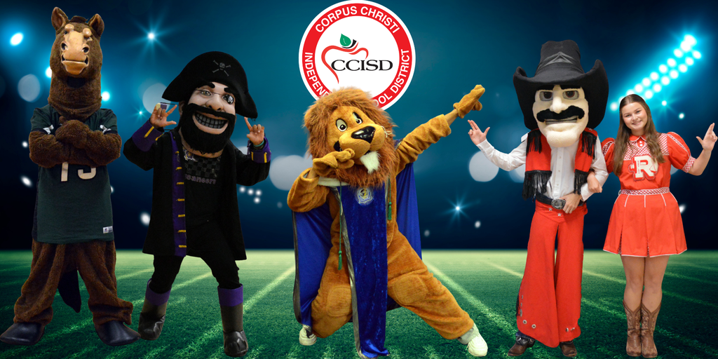 Five mascots in various costumes standing on a field. A woman in an orange dress and cowboy boots on the far right.