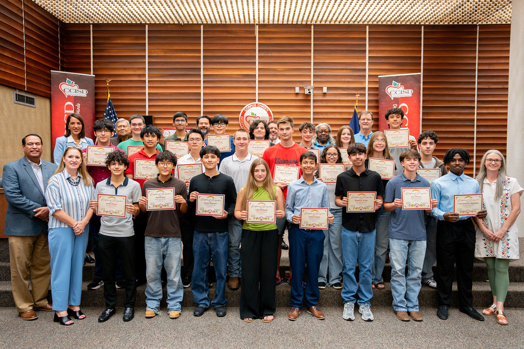 a group of veterans memorial high school students pose for a photo.