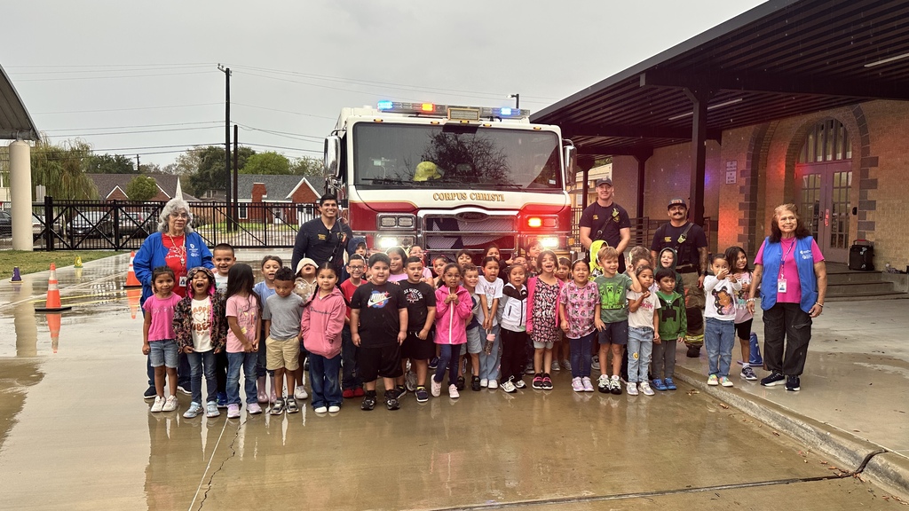 Student in front of firetruck. 