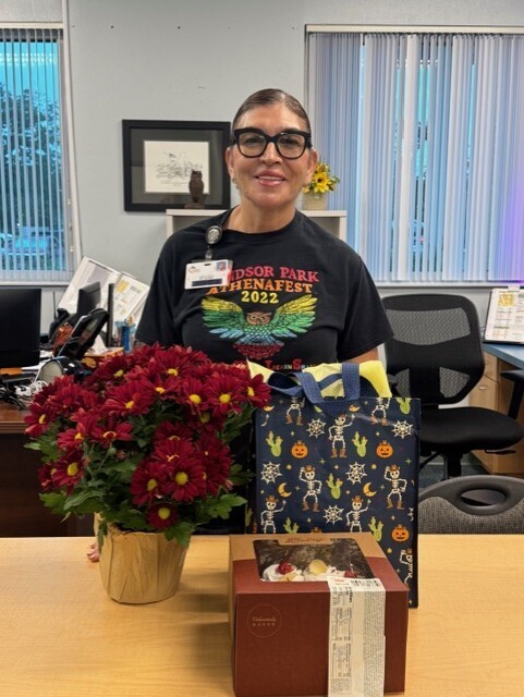 Picture of our school custodian with appreciation gifts.