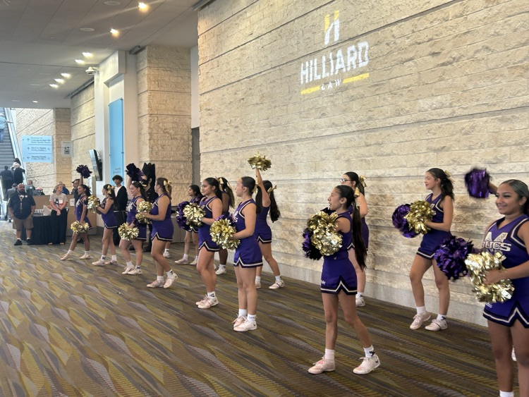 cheerleaders greet visitors as they arrive