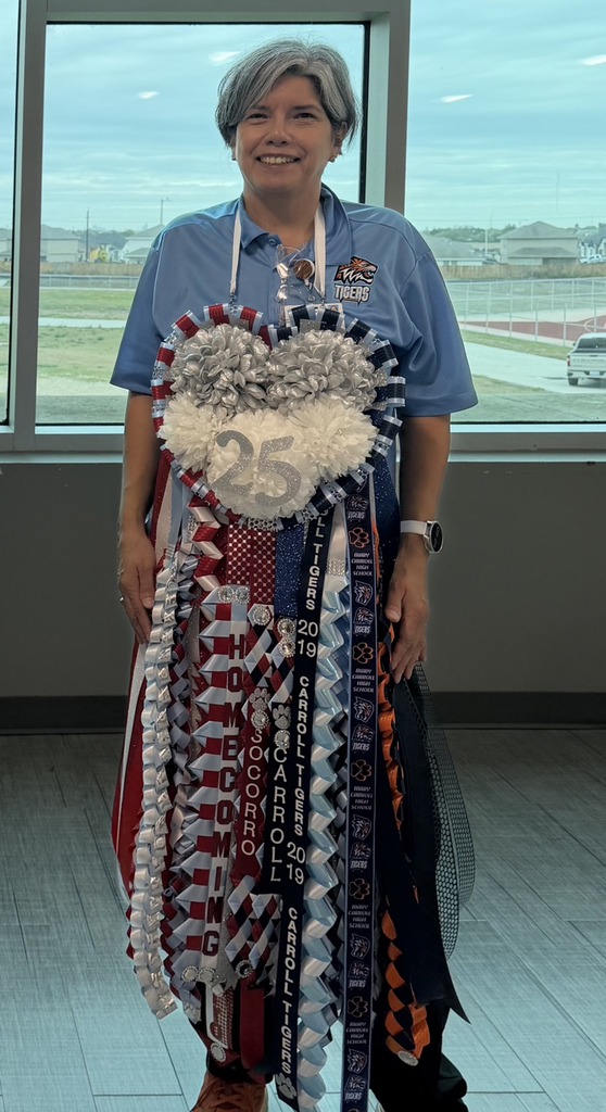 Adult wearing blue shirt and watch standing in front of window, holding a large decorative item.