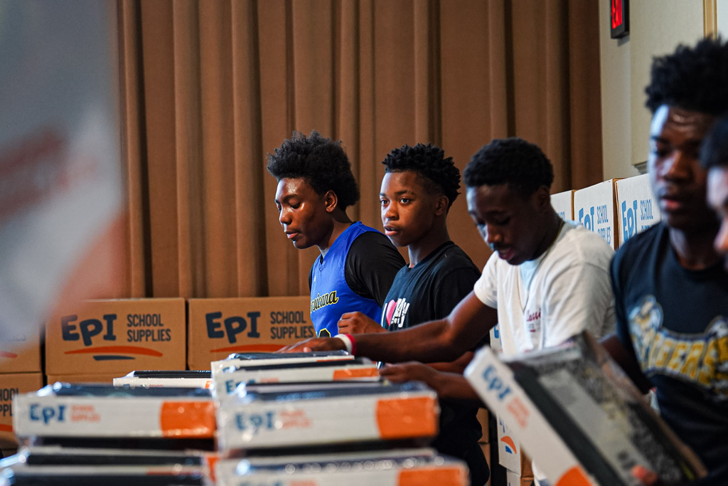 students helping with supplies